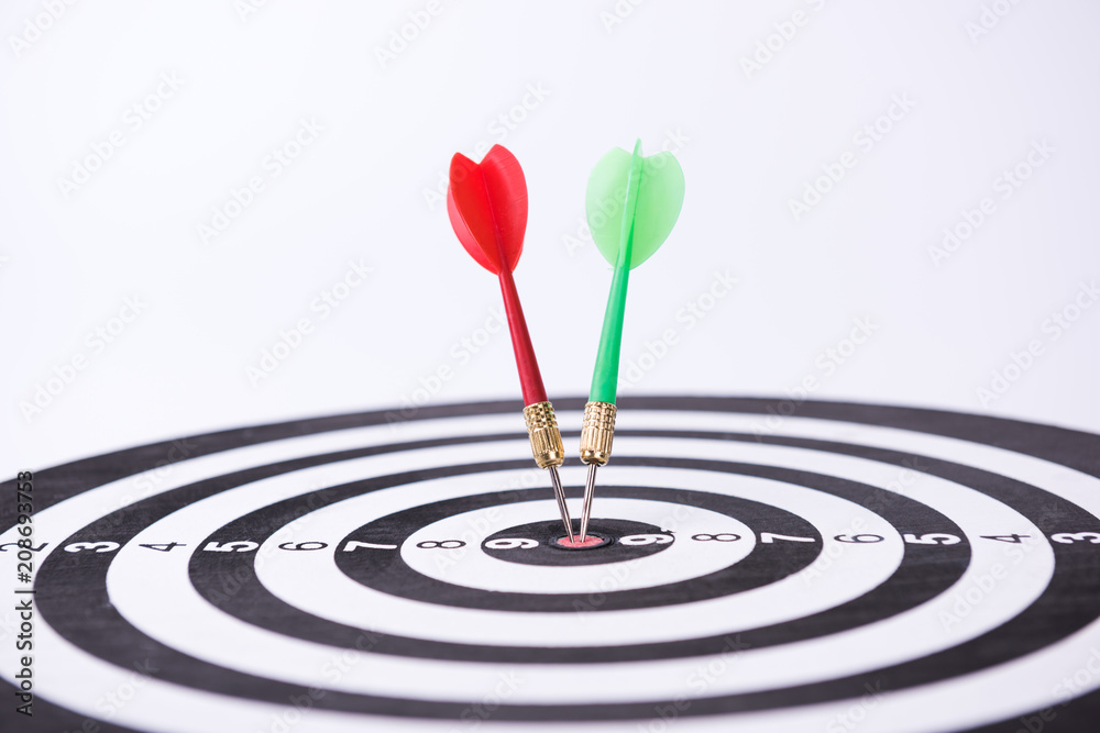 Dartboard with Darts Hitting the Bullseye Dartboard with Darts Hitting the Bullseye