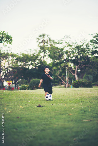 Little Boy playing soccer football