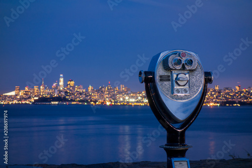 Sightseeing viewfinder at Vista Point near Golden Gate Bridge with San Francisco city skyline at night
