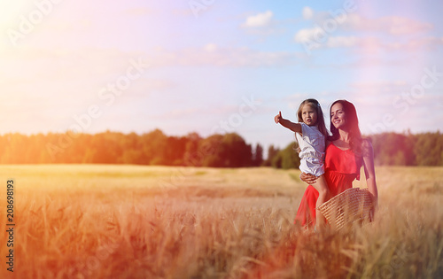 Young girl in a wheat field. Summer landscape and a girl on a na