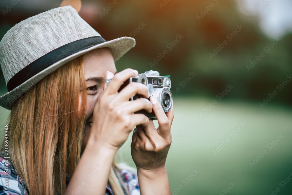 Young woman model with retro film camera