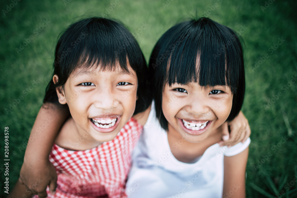 Two little girls friends playing funny in the park Two little girls friends playing funny in the park