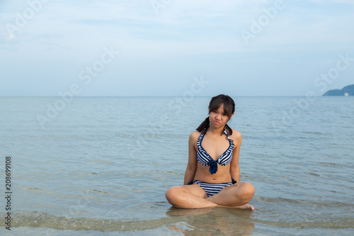 Teenage wearing bikini at the beach.