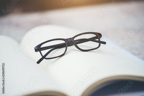 black glasses and book