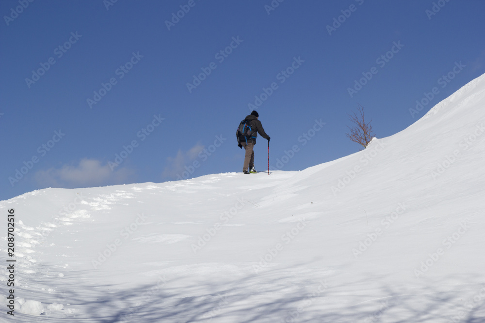 hikers walking in the snow in mountain