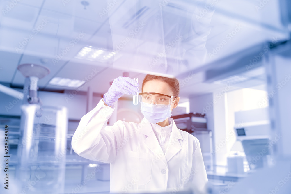 Female scientist looking at the scientific sample in the CDC laboratory Female scientist looking at the scientific sample in the CDC laboratory