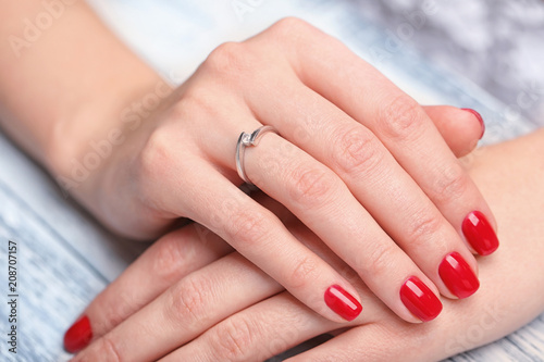 Woman wearing beautiful engagement ring  closeup