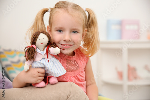 Cute little girl playing wi...