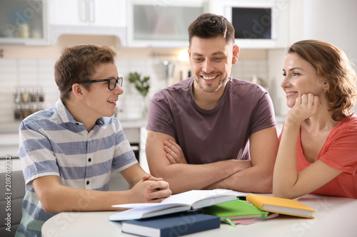 Teenager with parents doing...