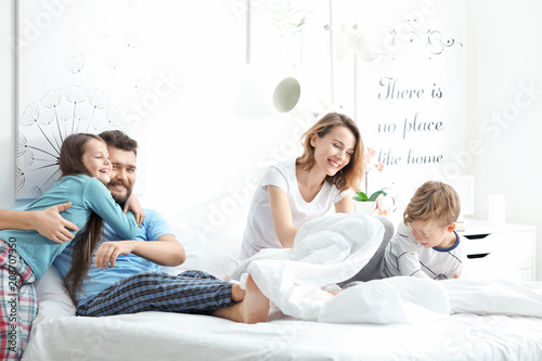 Beautiful morning of happy family in bedroom