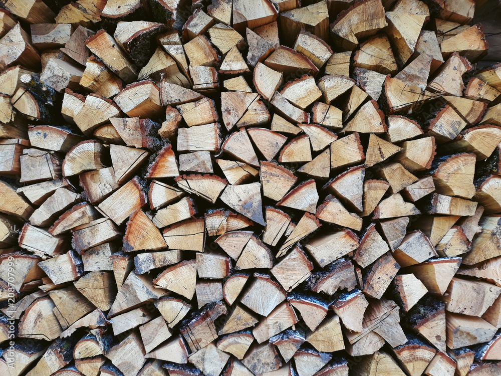 Firewood background, wall firewood, background of dry chopped firewood logs in a pile