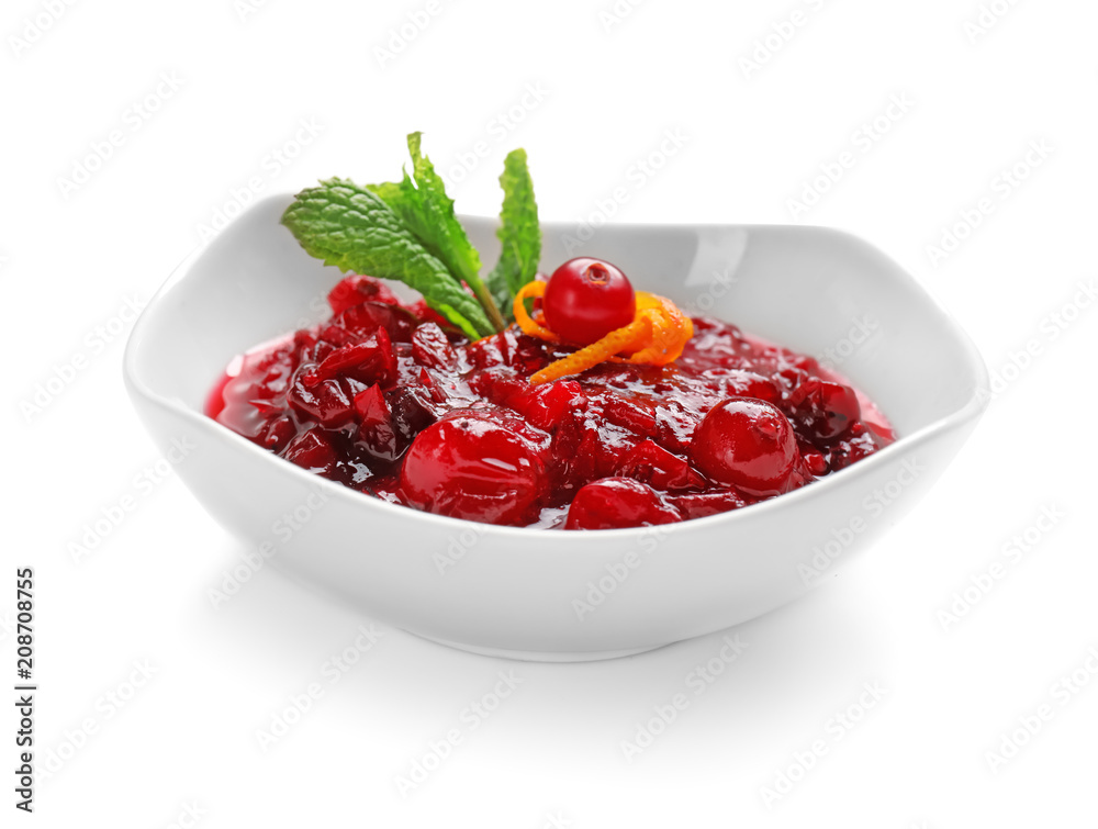 Bowl with tasty cranberry sauce and mint on white background Bowl with tasty cranberry sauce and mint on white background
