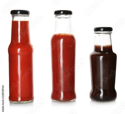 Bottles with tasty sauces on white background