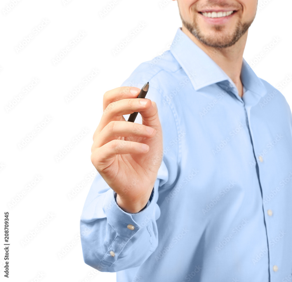 Young businessman writing on virtual screen against white background Young businessman writing on virtual screen against white background
