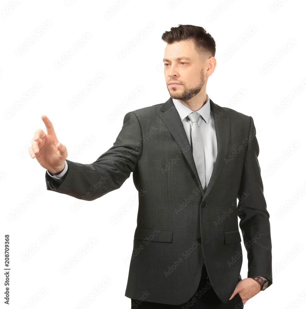 Young businessman using virtual screen on white background Young businessman using virtual screen on white background