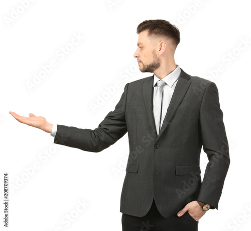 Young businessman holding something on white background
