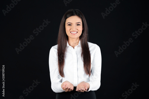 Young businesswoman holding...