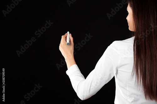 Businesswoman writing on in...