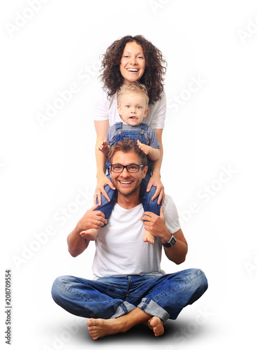 Happy young family laughing and smiling on light background
