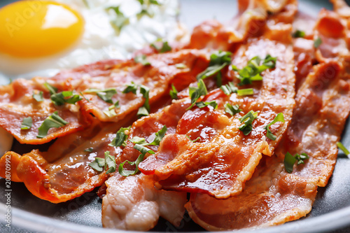 Tasty bacon on frying pan, closeup photo