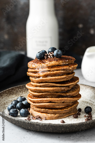 Oat pancakes with blueberry, chocolate and honey. Healthy pancakes. Healthy breakfast or snack concept. Closeup view stack of pancakes