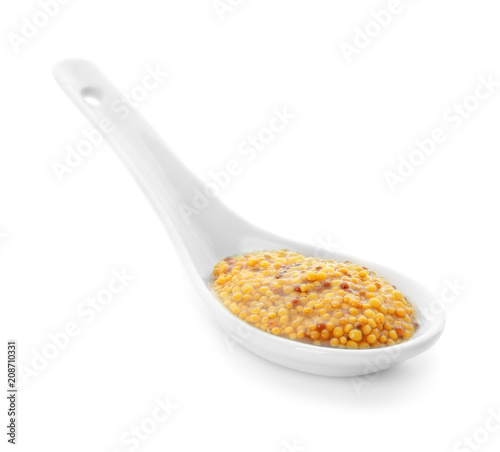 Dijon mustard in spoon on white background