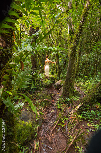 Girl walking through a rainyforest in Salazie, Reunion Island photo