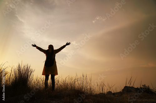 Silhouette of happy woman enjoying nature, enjoyment of nature and freedom