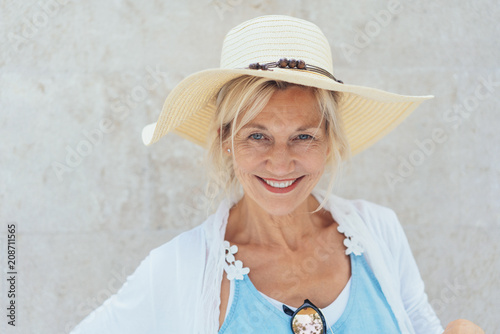 Charismatic blond woman in a trendy straw hat