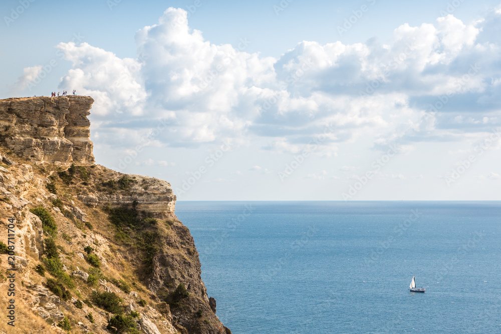 the rocky shore. high rocky cliff and sailboat at sea. Fiolent, Crimea