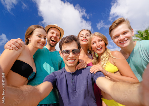 Having fun on the beach together. Vacation with friends. Group of young people taking selfie on the beach.