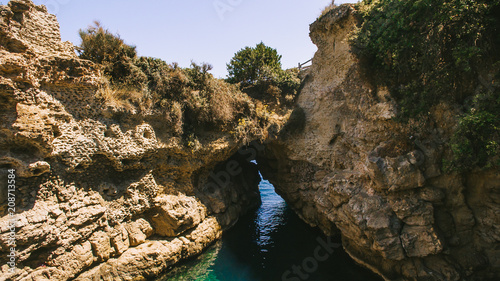 an arch in the sea between the rocks
