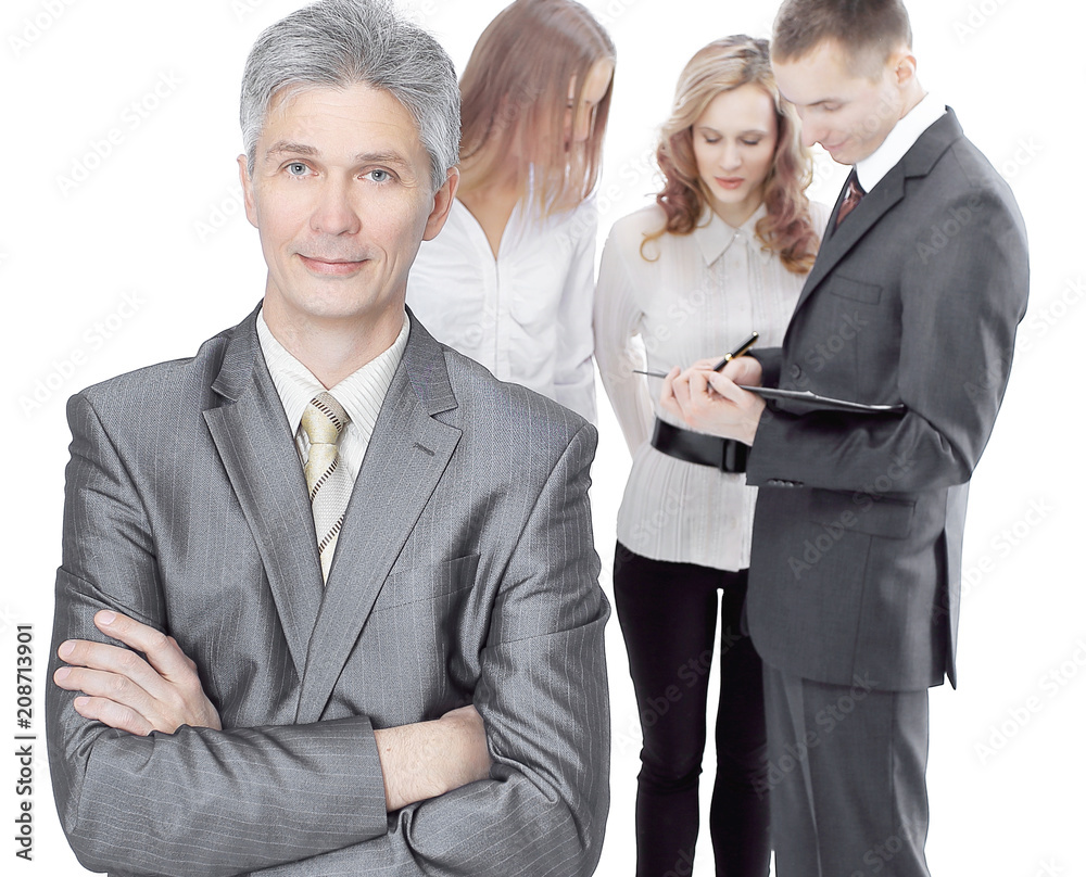 portrait of successful businessman on background of employees portrait of successful businessman on background of employees