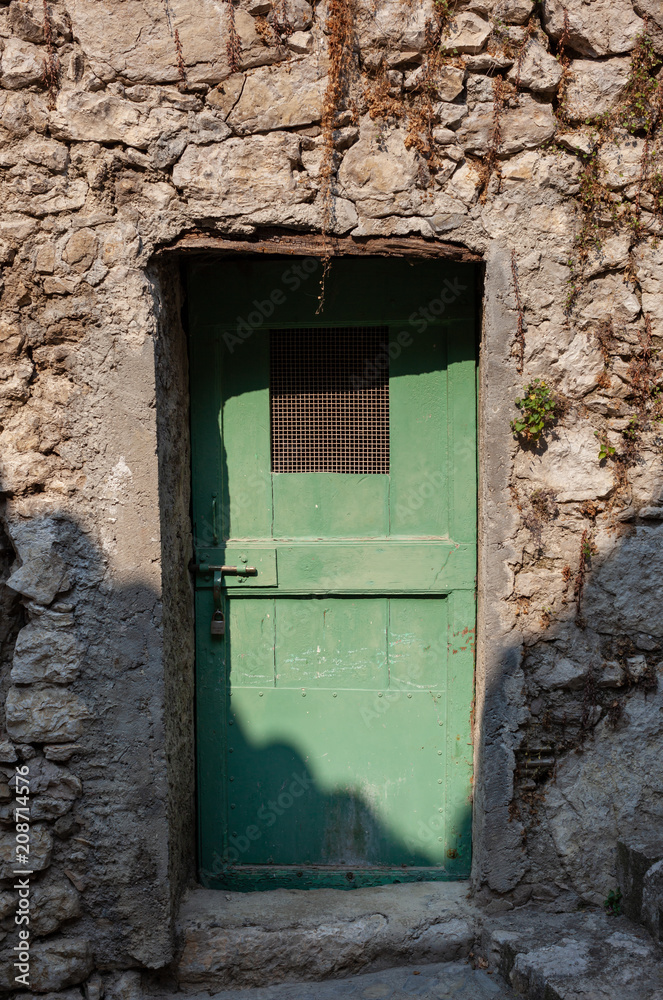 Old green door in Peillon, France