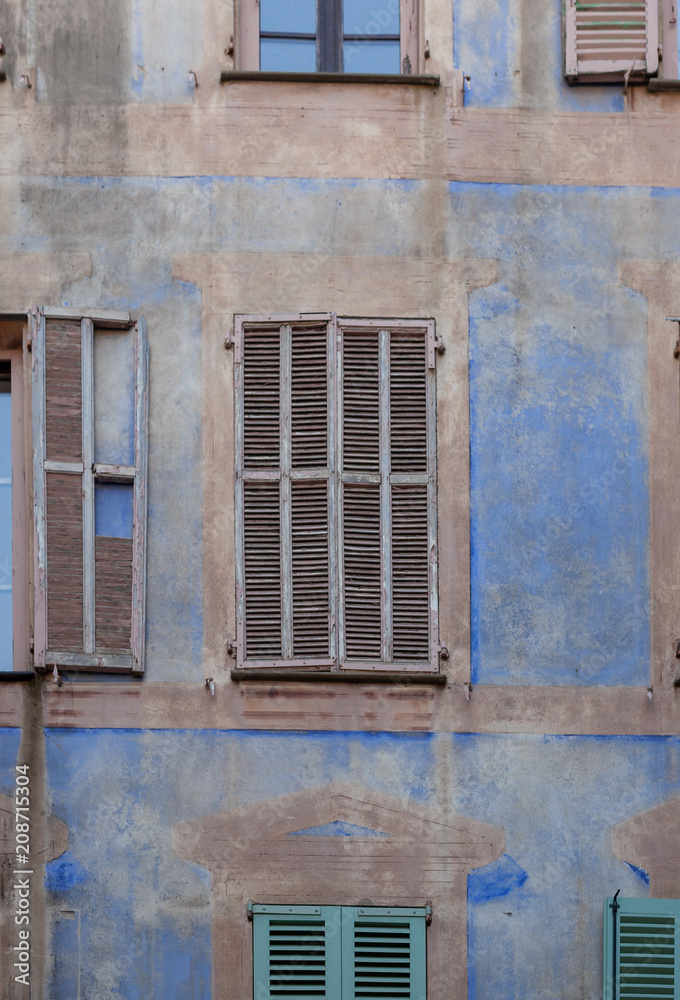Old shutters on a blue wall in Peille, France