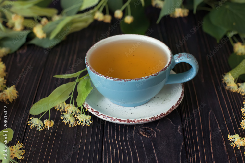 Linden herbal tea on dark wooden background Linden herbal tea on dark wooden background