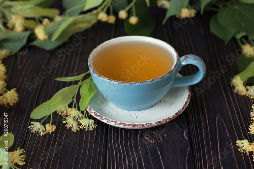 Linden herbal tea on dark wooden background