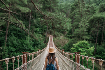 Woman on rope bridge