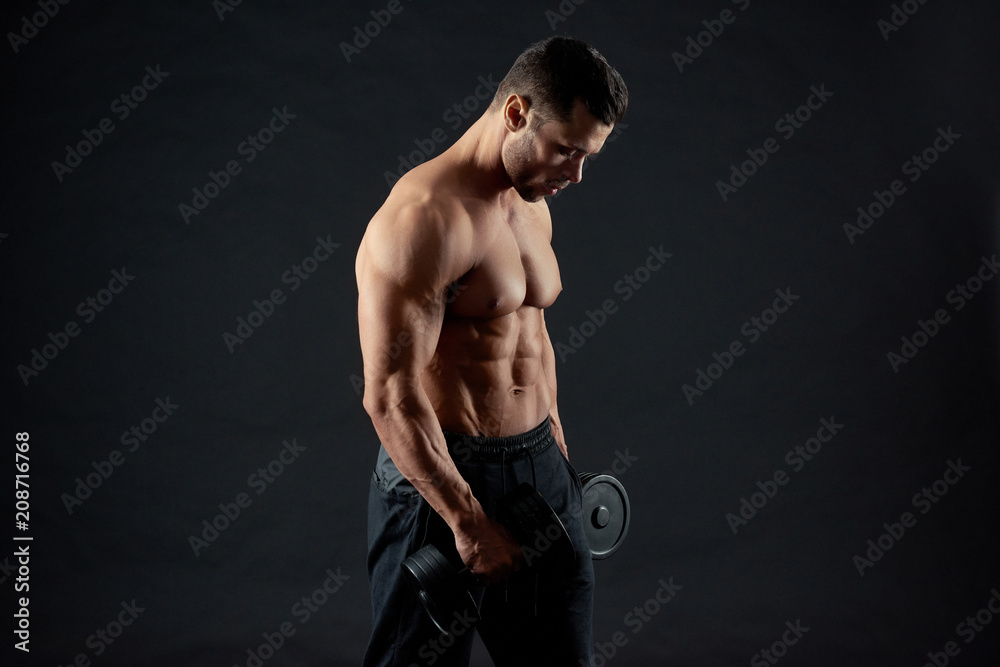 Sexy sporty muscular bodybuilder body. Sportsman training in gym,  exercising with heavy dumbbels. Model having clear muscles relief. Sport  lifestyle. Regular gym trainings. Fit sporty body. Lifestyle. Stock Photo |  Adobe Stock