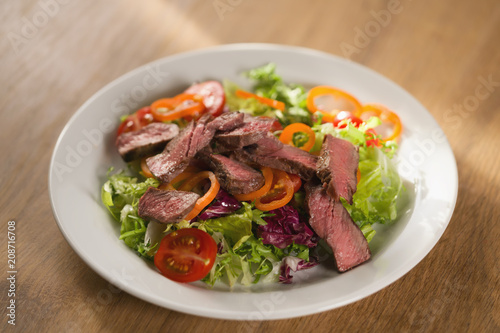 salad with sliced filet mignon steak