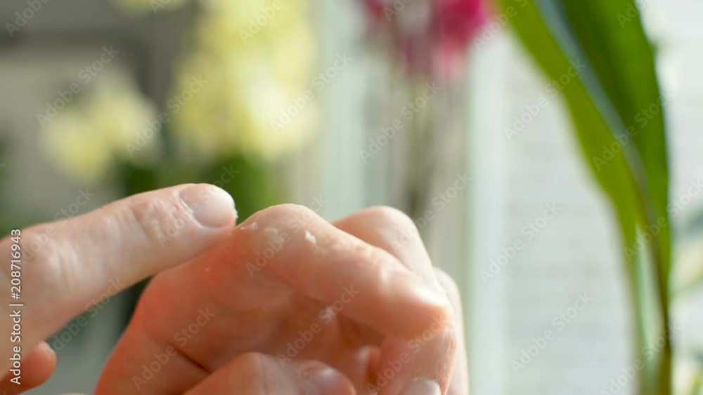 Applying lation cream balm moisturizer to damaged dry dehydrated finger skin Applying lation cream balm moisturizer to damaged dry dehydrated finger skin