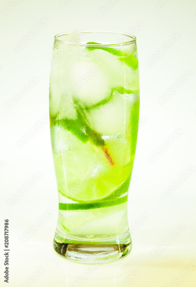 summer cold drink mojito lime and mint with ice and soda with drops on a glass on a white background summer cold drink mojito lime and mint with ice and soda with drops on a glass on a white background