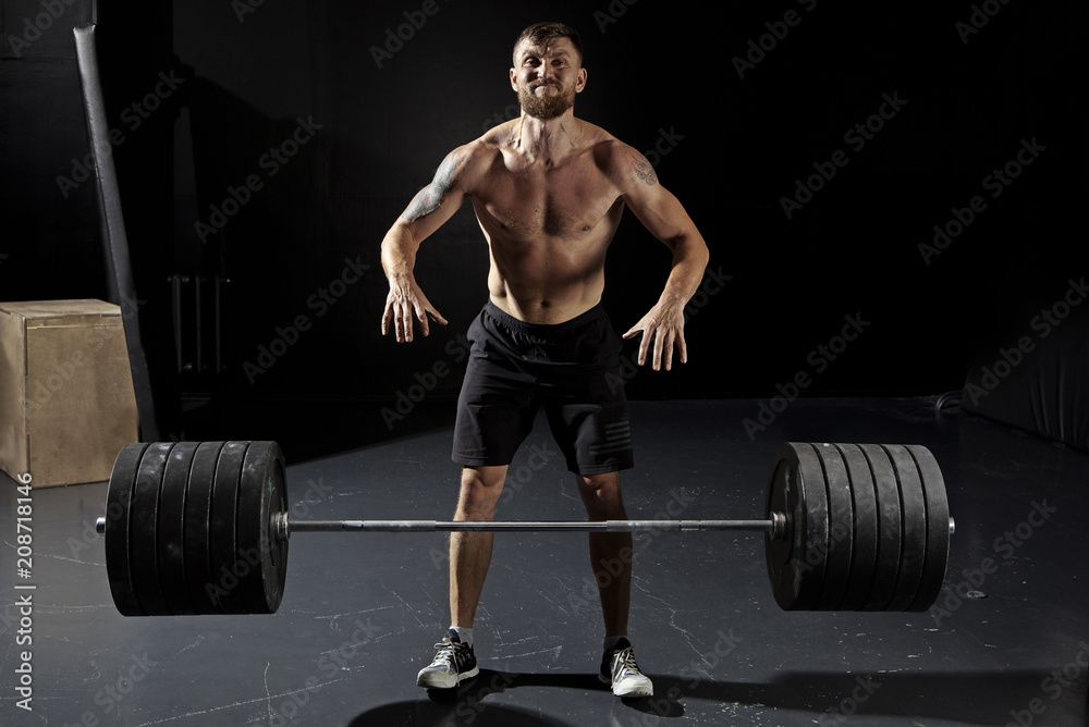 Man workout with barbell at gym