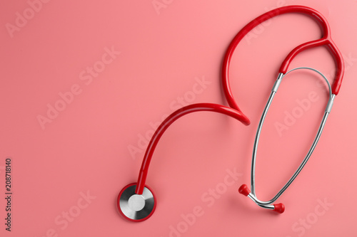 Stethoscope on color background