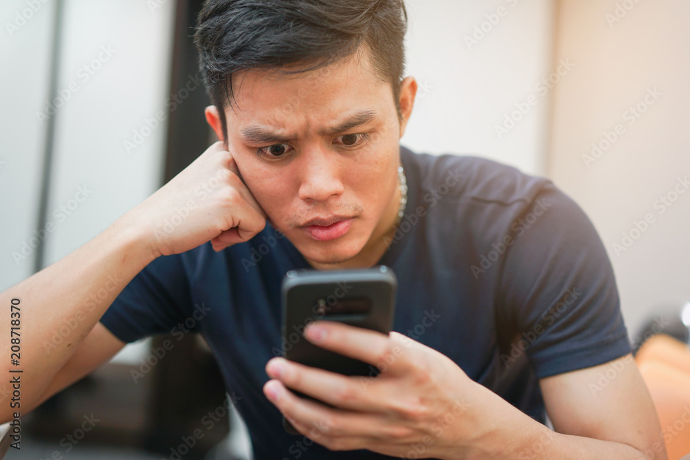 close up asian man feeling surprise when watch smartphone close up asian man feeling surprise when watch smartphone