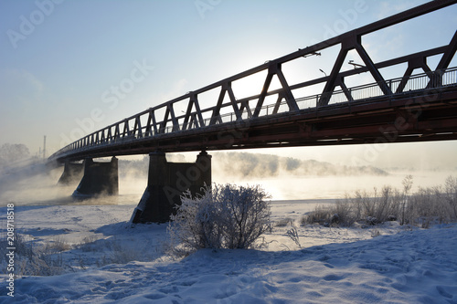 Sunny winter day with bridge over the river, which does not freeze. © Happy Dragon