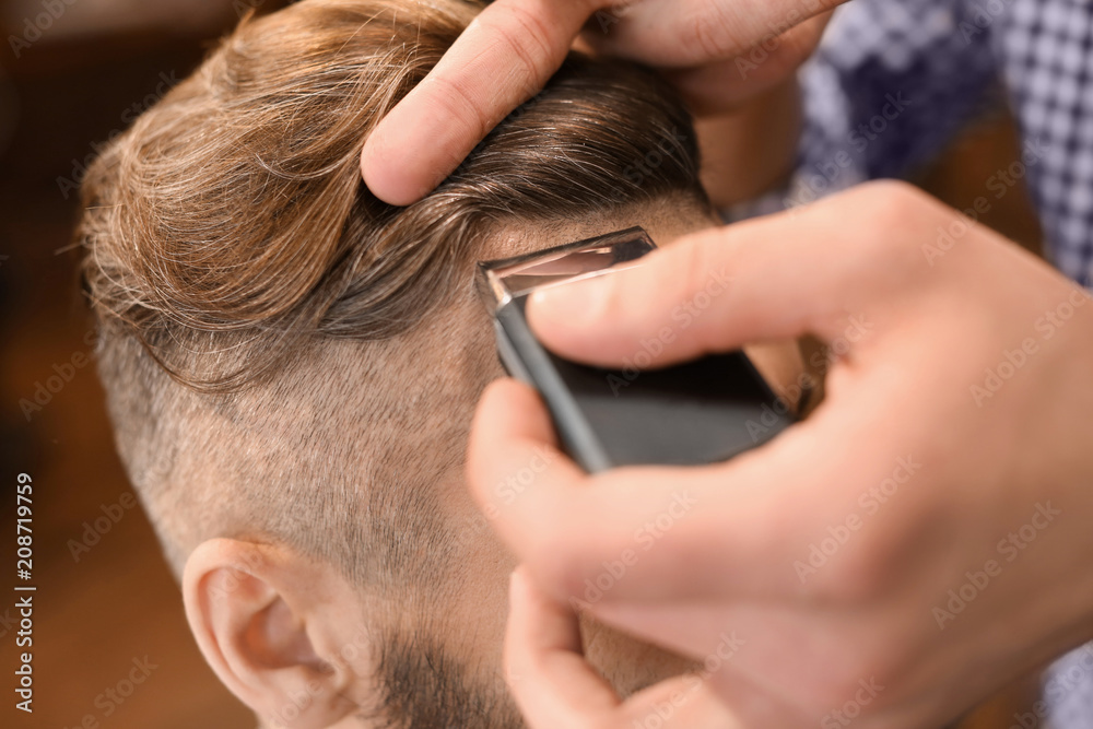 Professional barber working with client in hairdressing salon Professional barber working with client in hairdressing salon