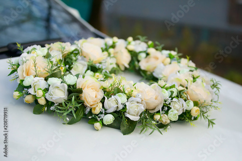 The composition from fresh flowers on the holiday car.