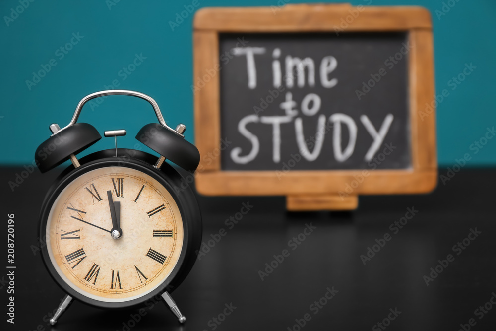 Alarm clock and chalkboard with phrase Alarm clock and chalkboard with phrase