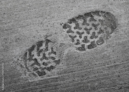 footprint of shoe or boot on concrete